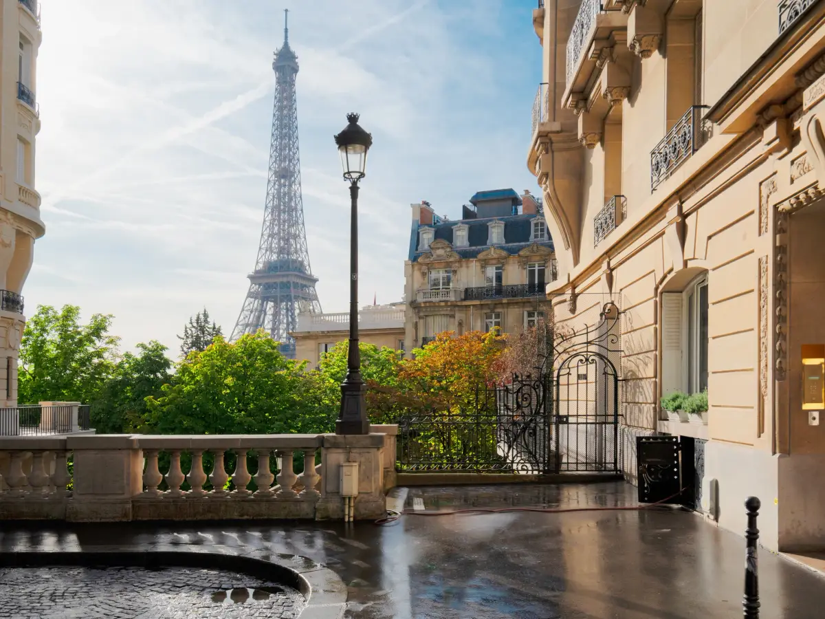 A stone balustrade and the rooftops of Paris beyond