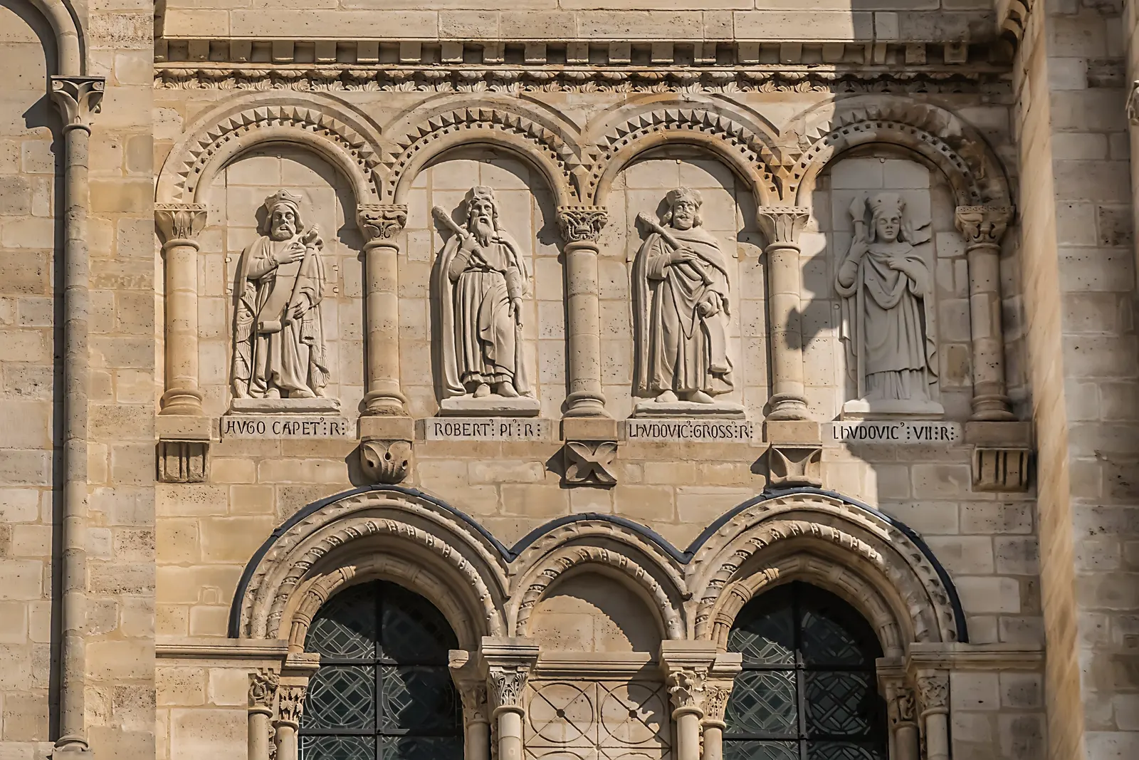 The portal of the Saint-Denis cathedral basilica, its Romanesque arches and the statues of the kings of France above the doors