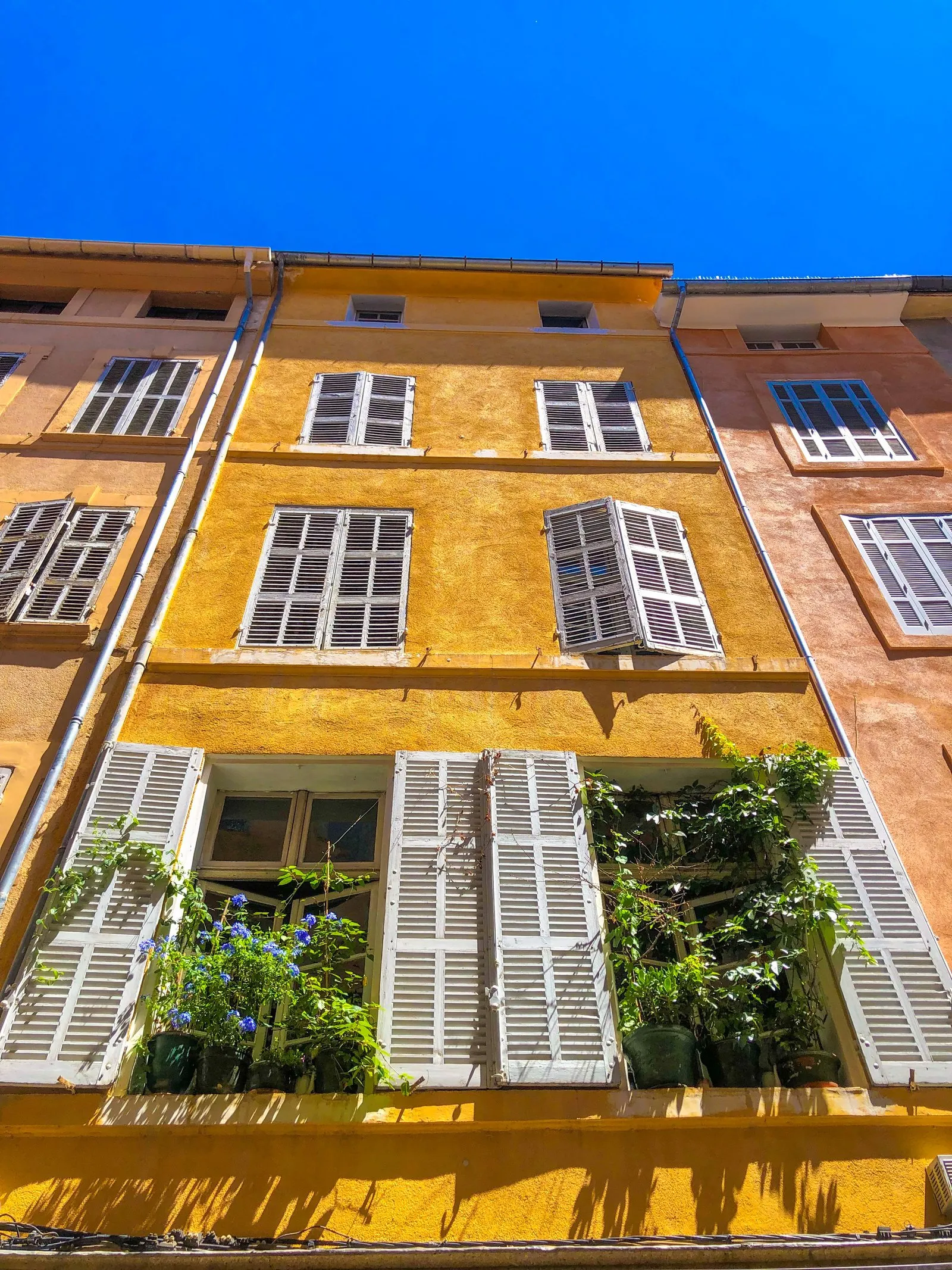An ochre façade with shutters in Aix-en-Provence