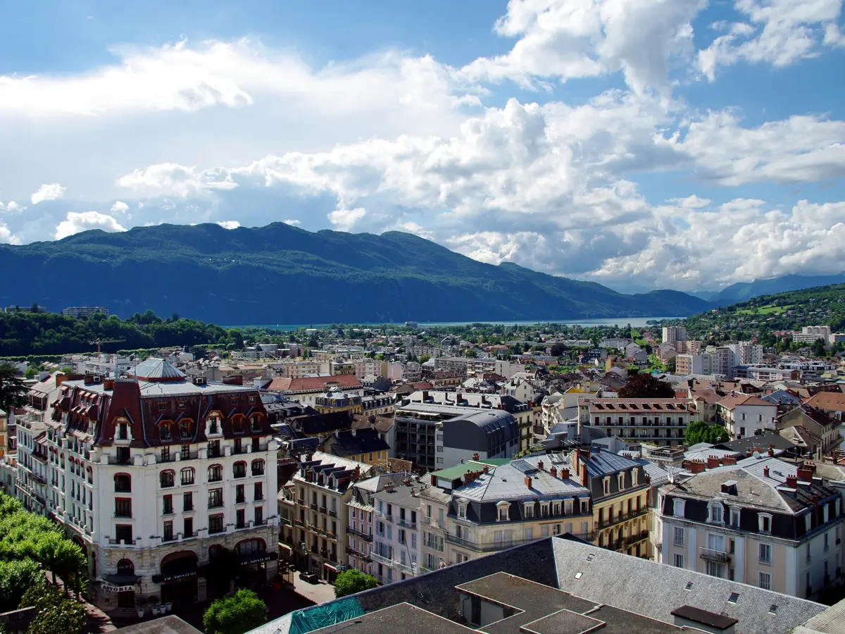 The rooftops of Aix-les-Bains, its Belle Époque palace hotels and Lac du Bourget in the distance, beneath the mountains