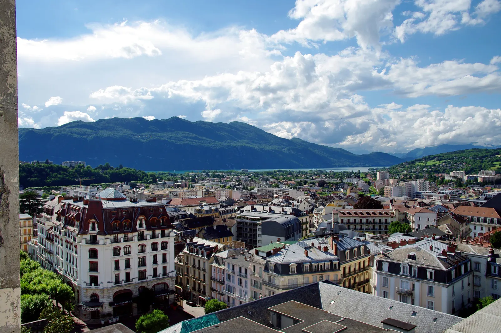 The rooftops of Aix-les-Bains, its Belle Époque palace hotels and Lac du Bourget in the distance, beneath the mountains