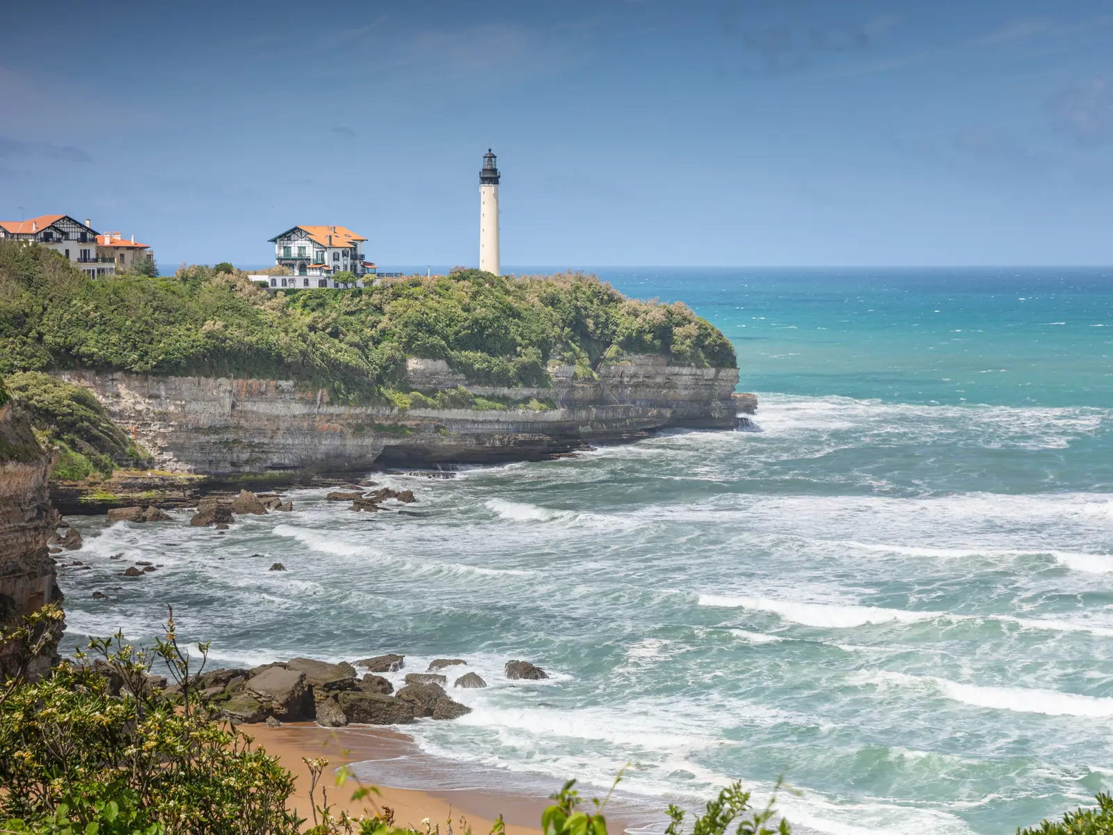 La plage de la Chambre d’Amour à Anglet, au pied de la falaise où veille le phare de Biarritz, l’océan turquoise et ses rouleaux