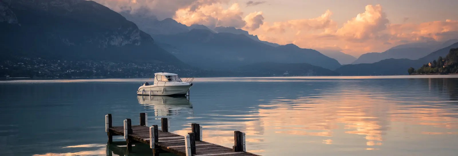 A wooden jetty on Lake Annecy at daybreak