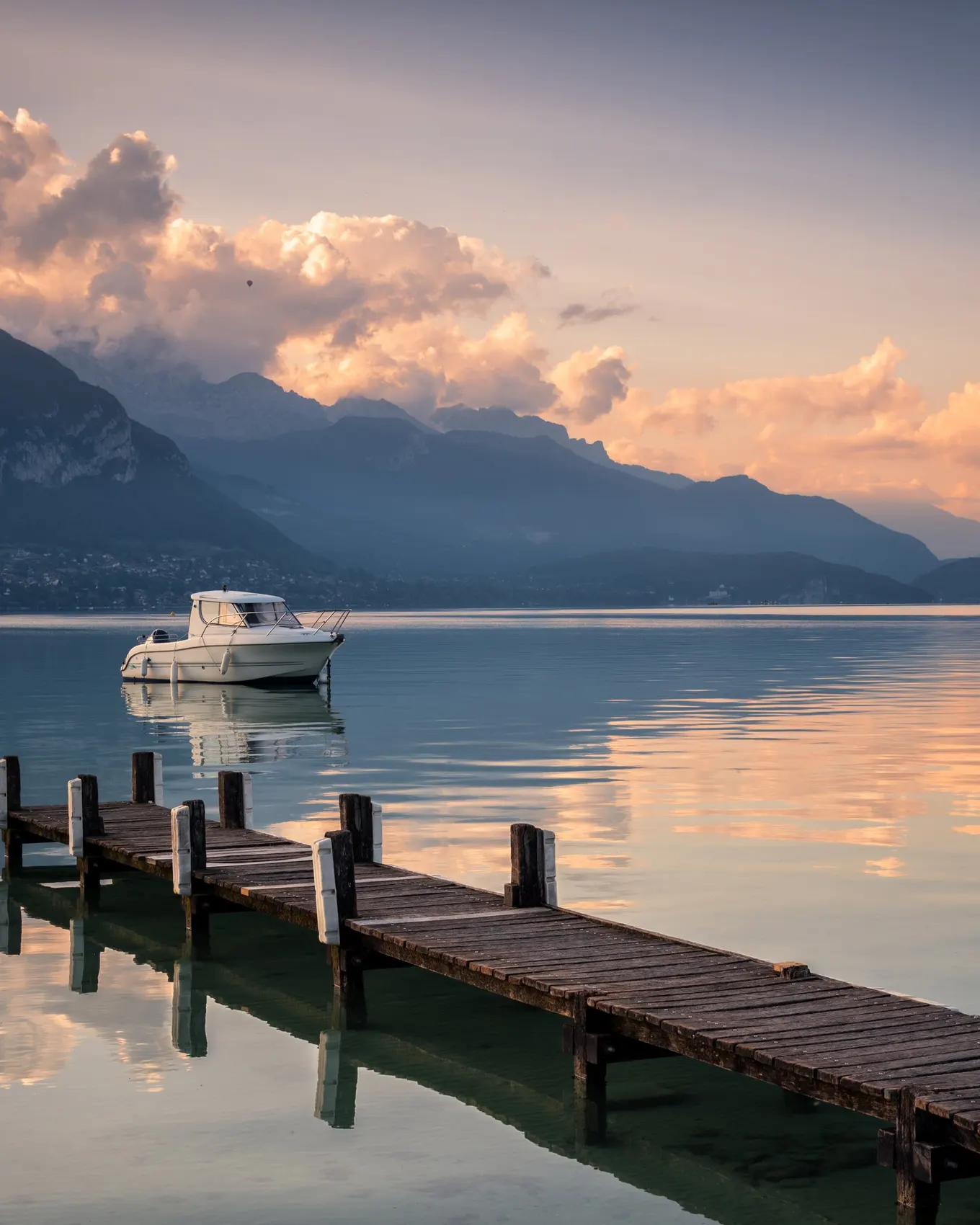 A wooden jetty on Lake Annecy at daybreak