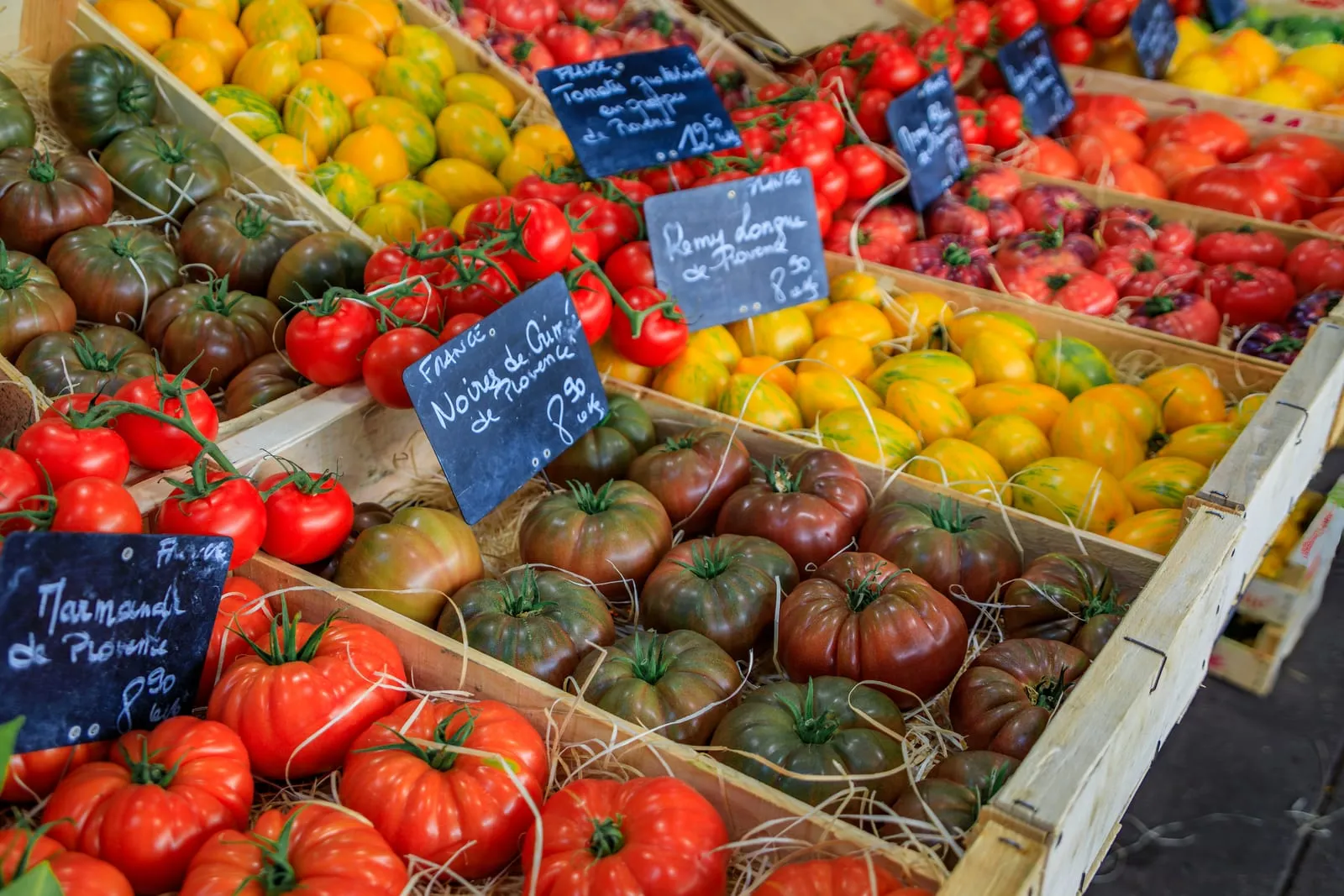 A stall of tomatoes and vegetables at the market