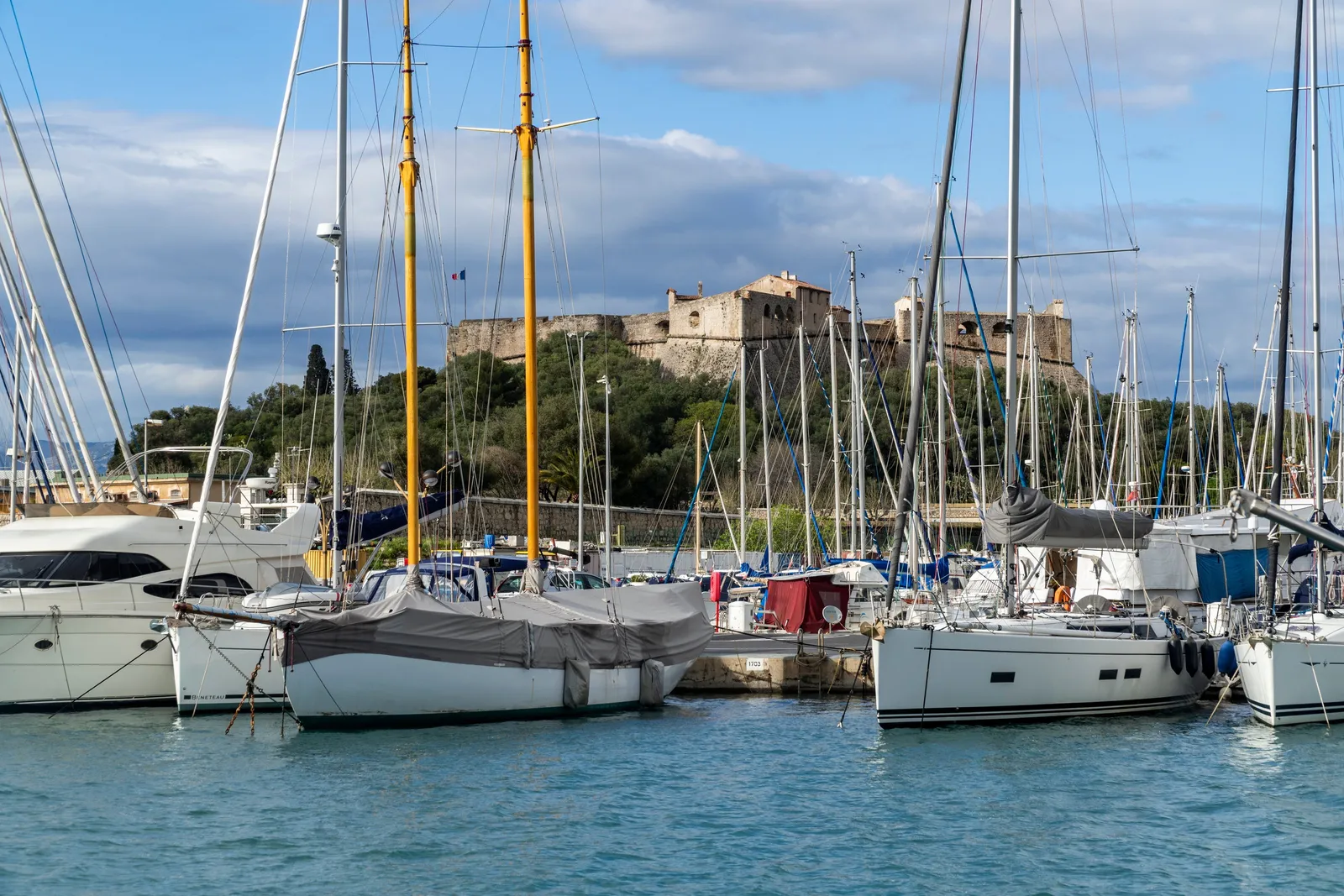 Yachts moored in the harbour, the fort’s ramparts behind