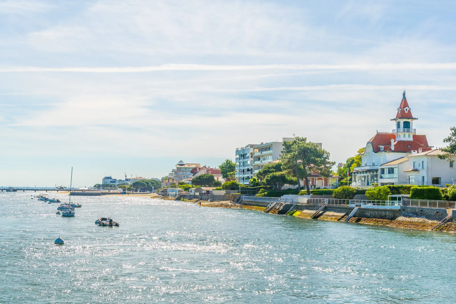 The Arcachon seafront, its turreted villa and its boats moored on the bay