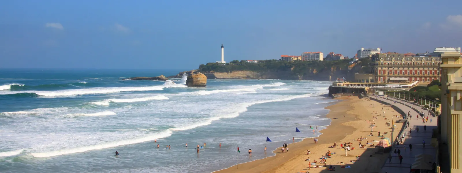 O farol no seu promontório, acima da praia