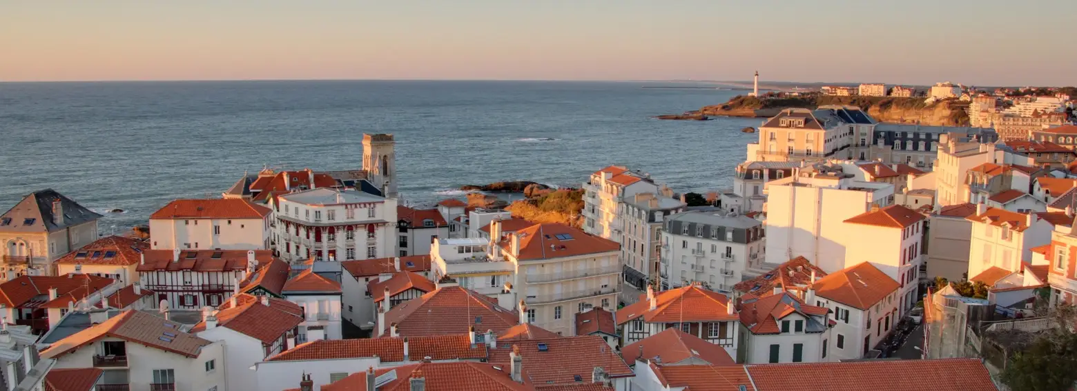 Os telhados de Biarritz ao pôr do sol, o oceano e o farol ao longe