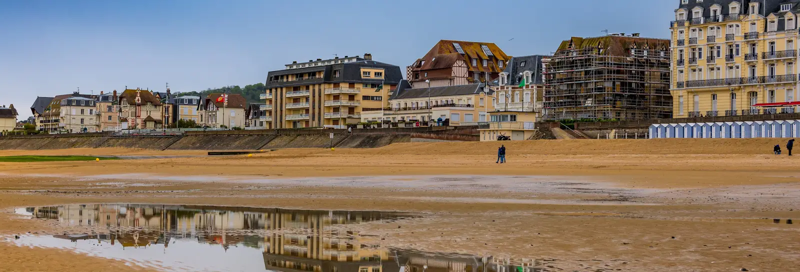 La plage de Cabourg à marée basse, le Grand Hôtel et les villas du front de mer reflétés dans le sable mouillé