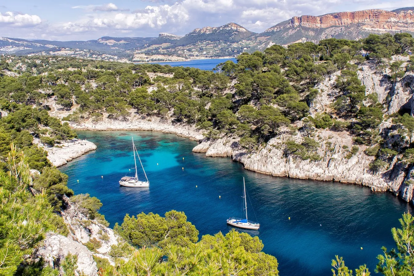 A calanque of Cassis and its yachts, Cap Canaille in the background