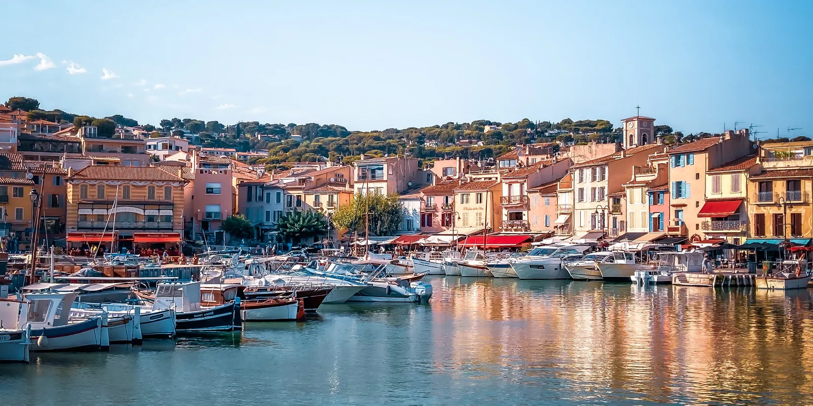 Cassis harbour and the village façades, with the hills behind
