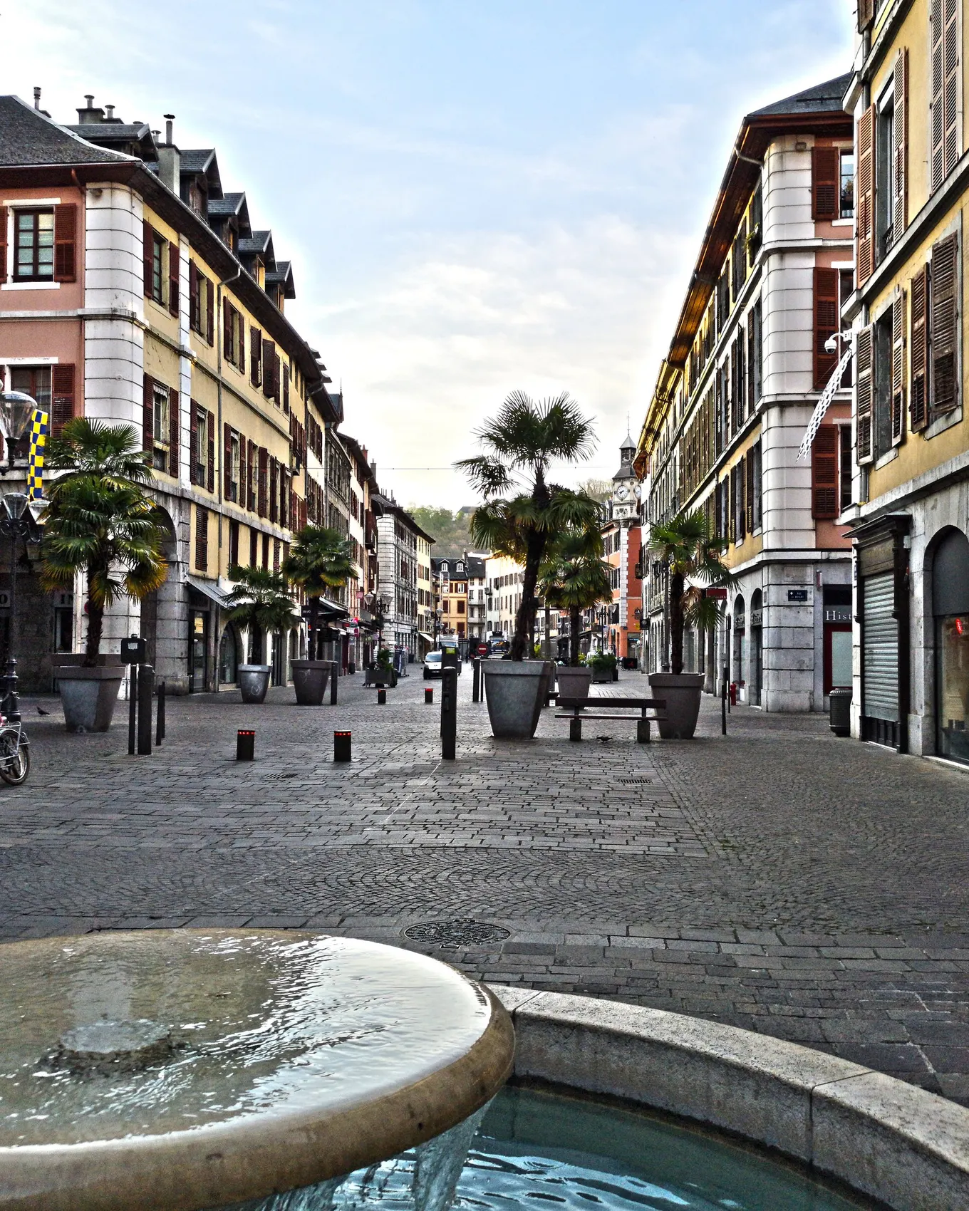 Place Saint-Léger in the old centre of Chambéry, its fountain, its potted palms and its colourful façades with painted shutters