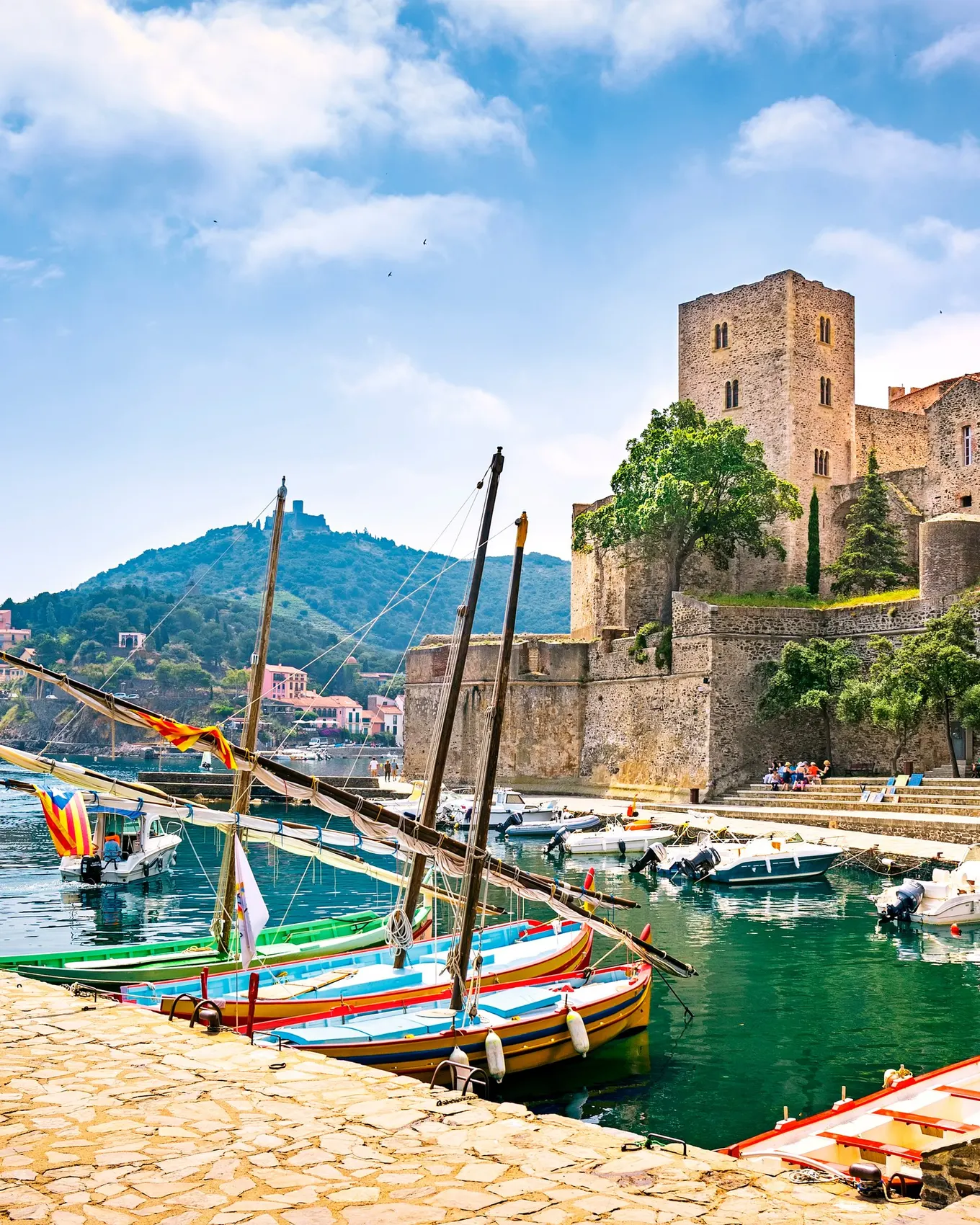 The royal château of Collioure, the Catalan fishing boats moored at the quay and Fort Saint-Elme on the hill