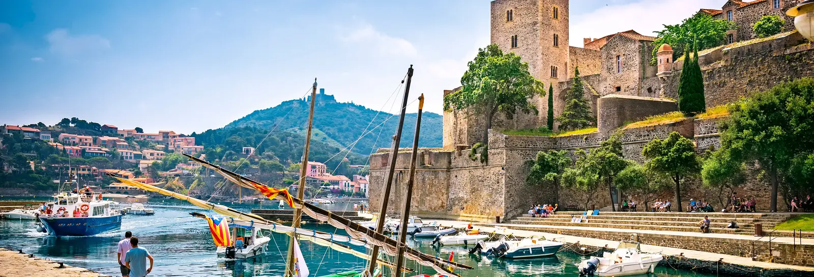 The royal château of Collioure, the Catalan fishing boats moored at the quay and Fort Saint-Elme on the hill