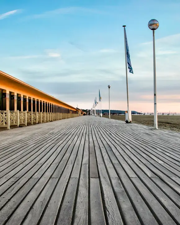 Les Planches, Deauville’s wooden boardwalk, and the beach stretching into the distance