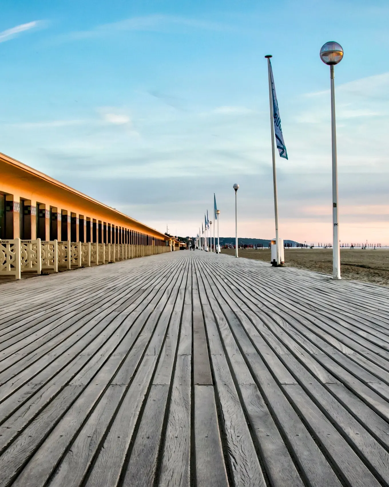 Les Planches, Deauville’s wooden boardwalk, and the beach stretching into the distance