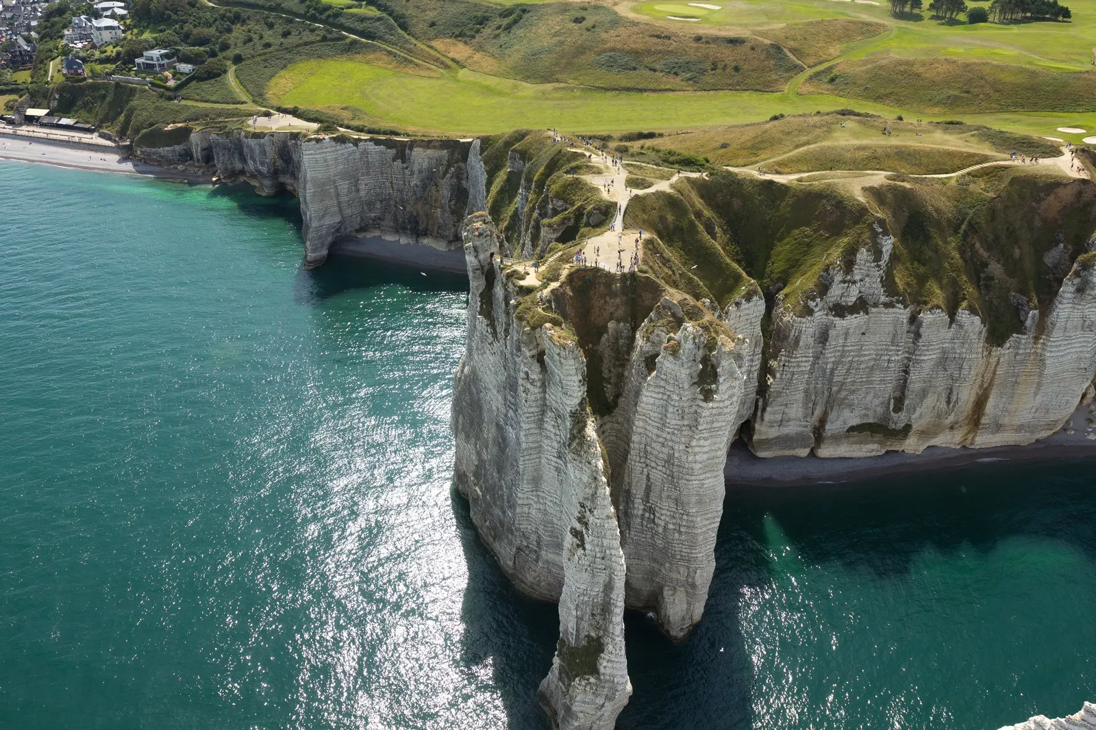 The cliffs of Étretat and the Aiguille from the sky, the turquoise sea and the meadows of the plateau