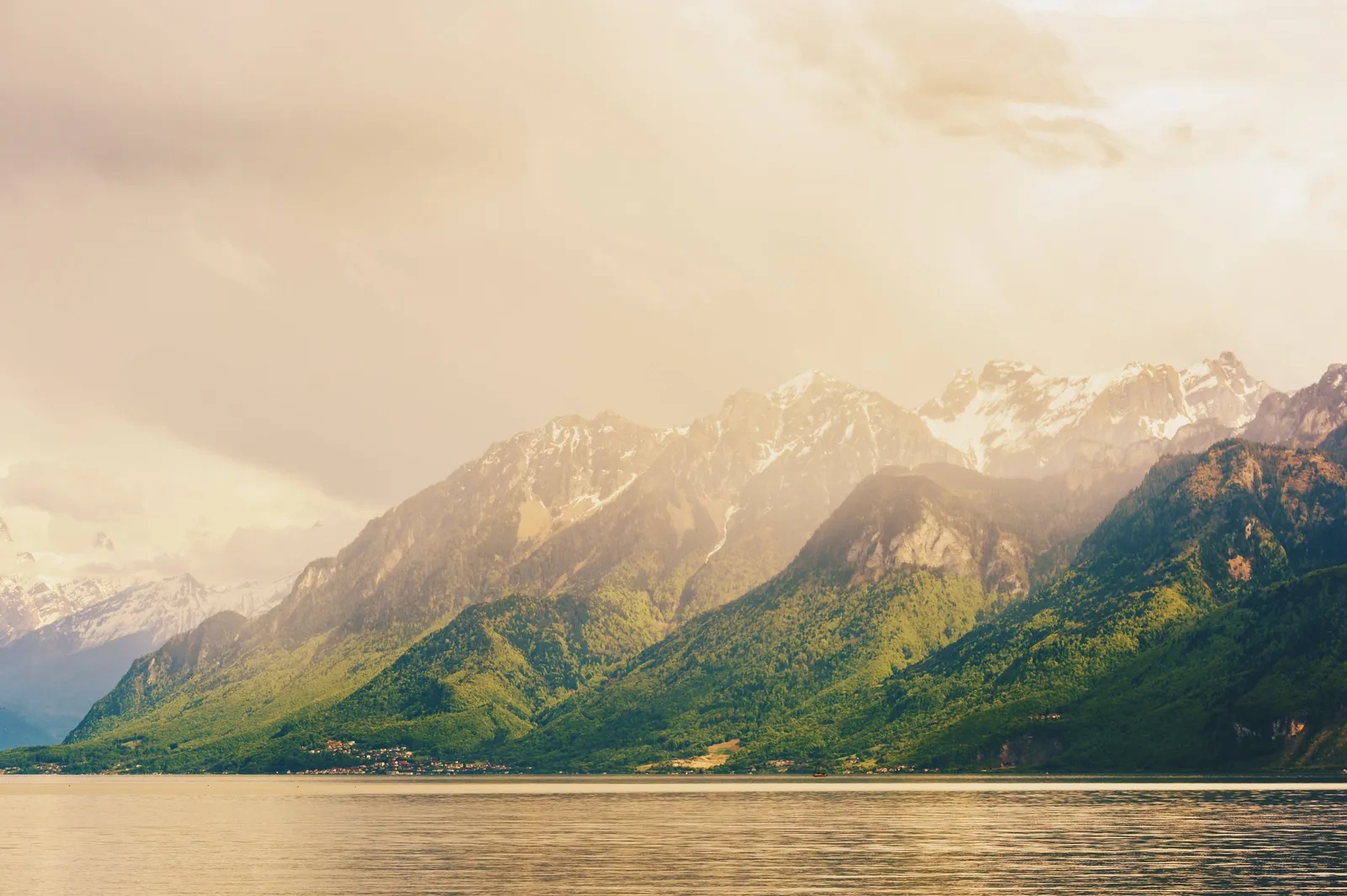 The Chablais mountains above Évian-les-Bains in the golden evening light, the town on the shore of Lake Geneva