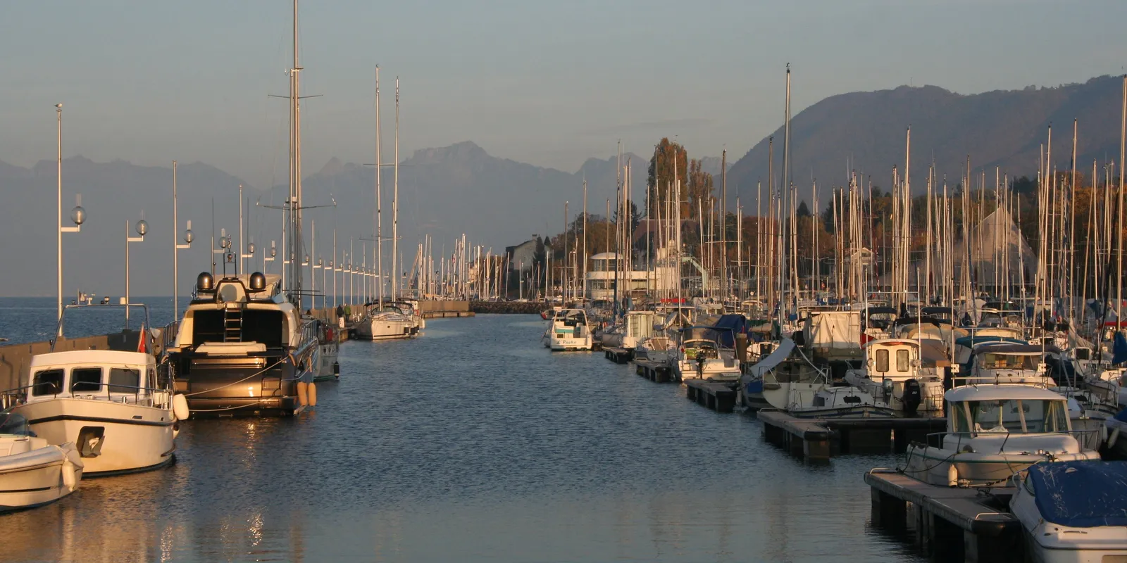 The port of Évian-les-Bains at sunset, facing the mountains
