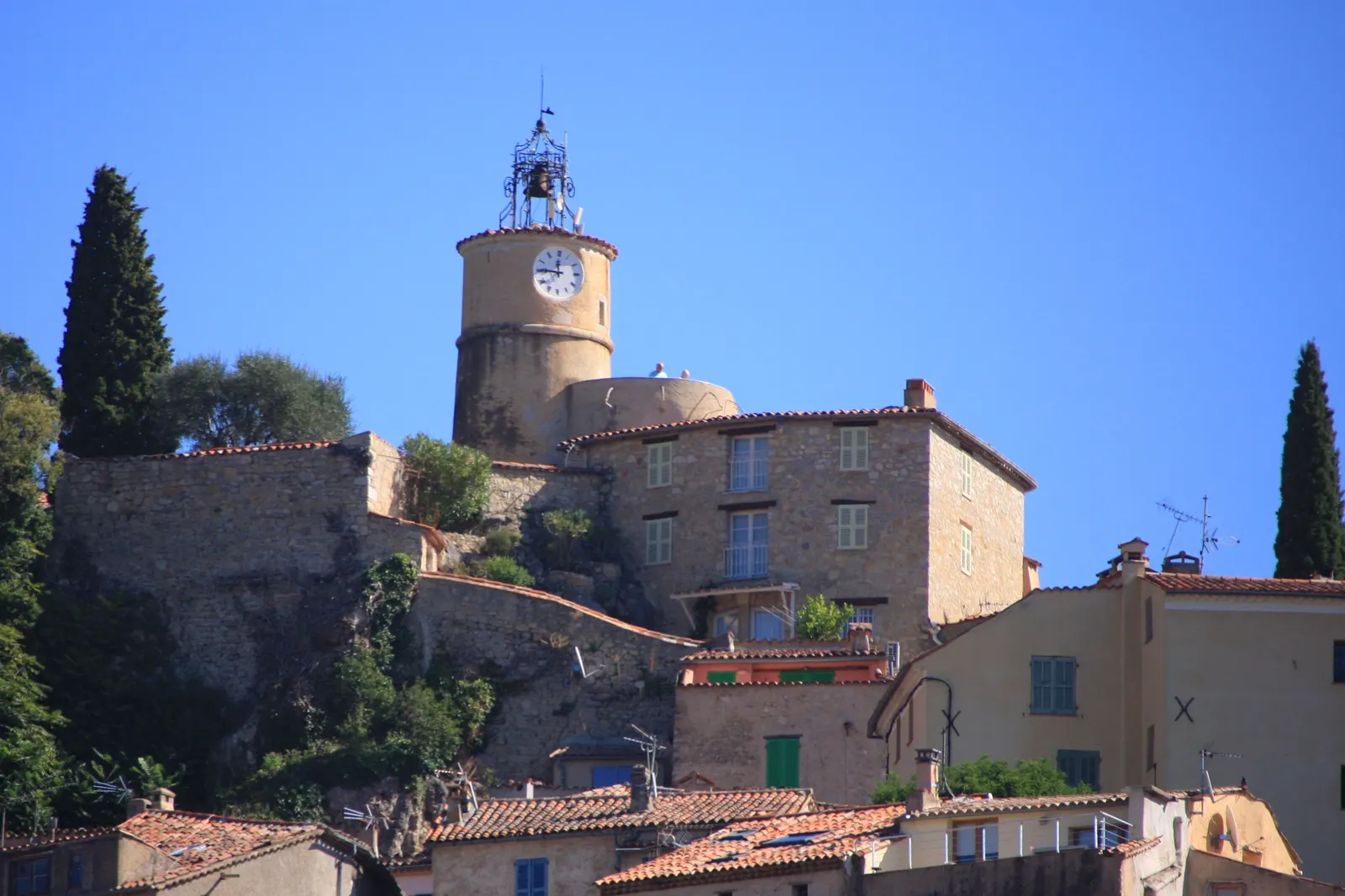 The hilltop village of Fayence, its clock tower crowned with a wrought-iron bell cage and its stone houses