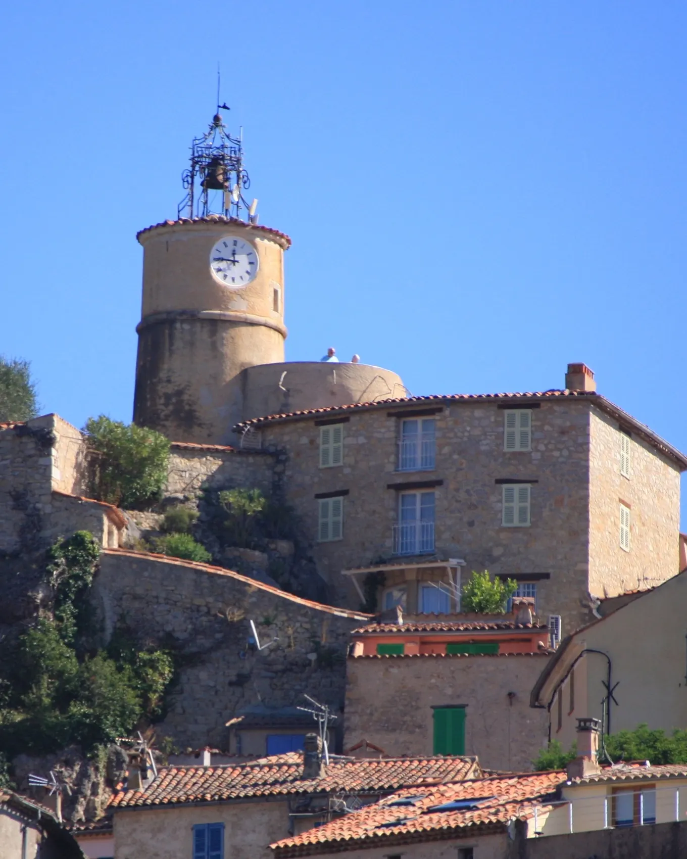 The hilltop village of Fayence, its clock tower crowned with a wrought-iron bell cage and its stone houses