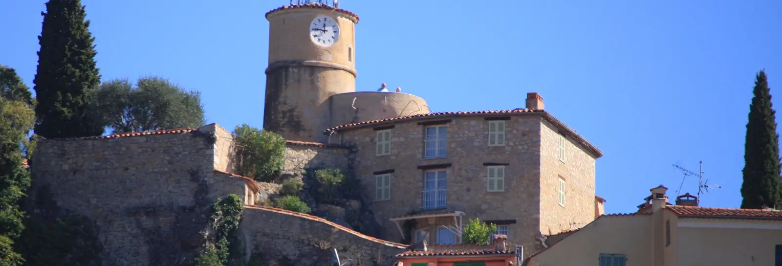 The hilltop village of Fayence, its clock tower crowned with a wrought-iron bell cage and its stone houses