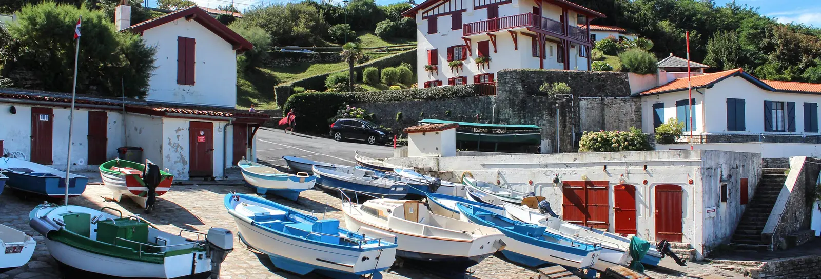The harbour of Guéthary, its boats hauled up on the slipway and the white Basque houses with red shutters