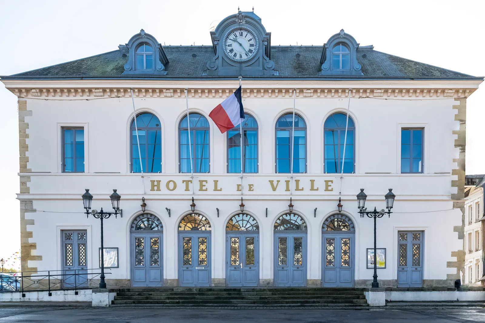 L’hôtel de ville de Honfleur, sa façade claire, ses fenêtres en arc et son horloge