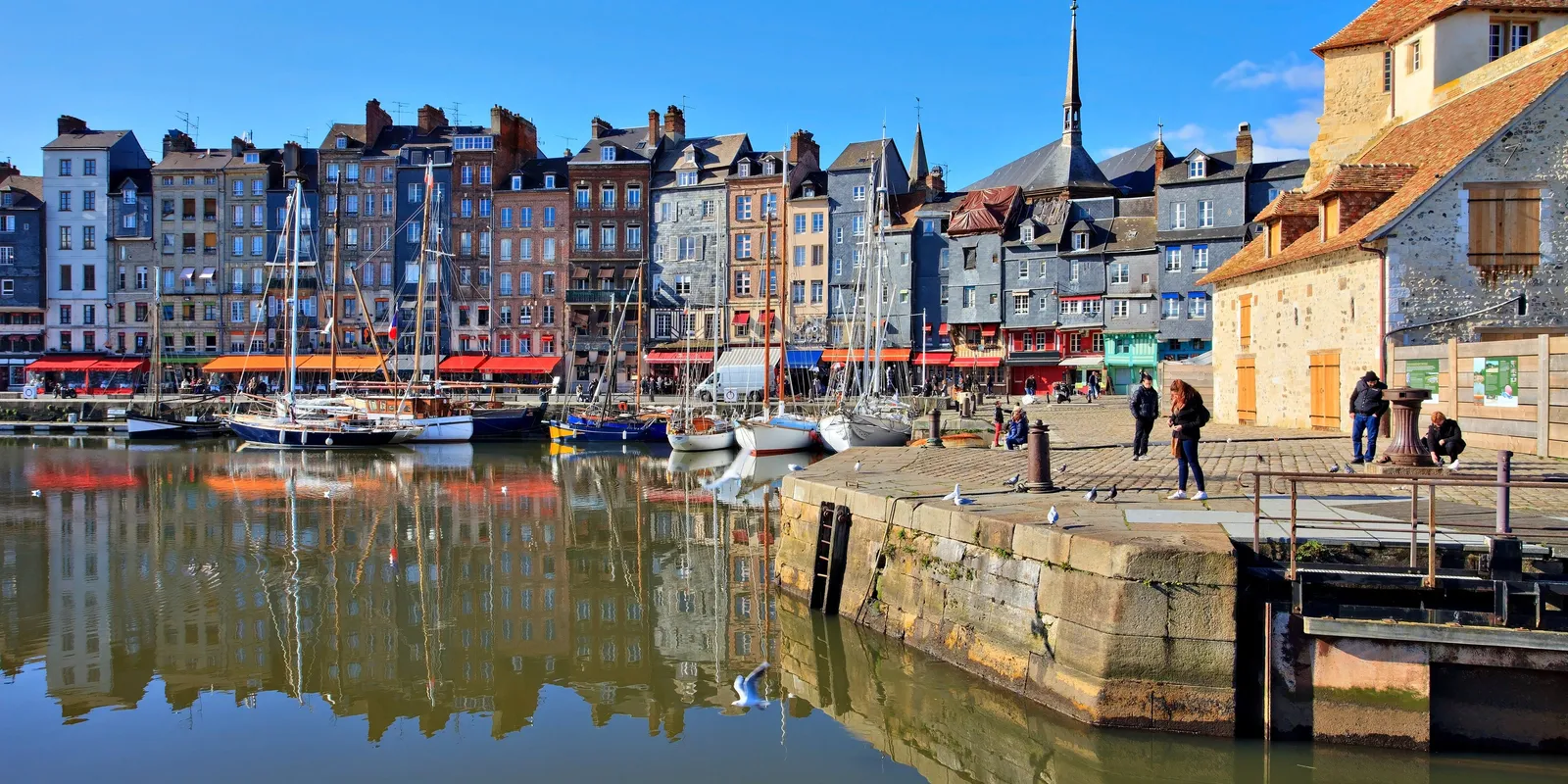 Le Vieux-Bassin de Honfleur, ses hautes maisons étroites aux façades d’ardoise et de couleur, et leurs reflets dans l’eau