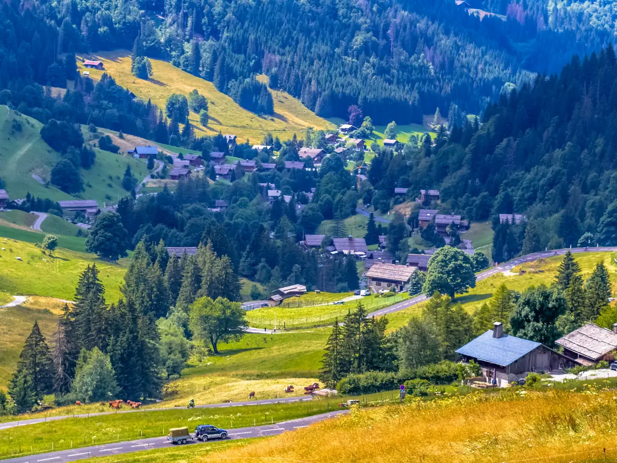 The La Clusaz valley seen from the Col des Aravis, its chalets in the meadows and the spruce forests