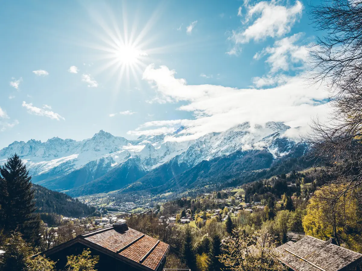 The Mont Blanc massif above the rooftops of the village of Les Houches, in autumn