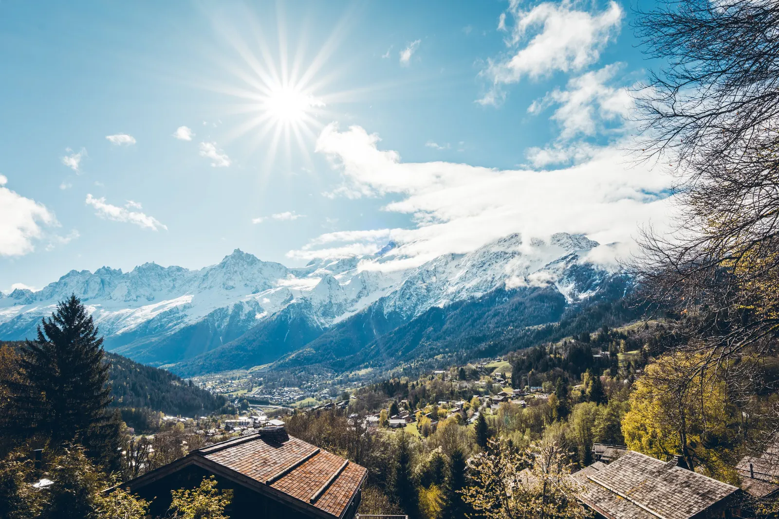 The Mont Blanc massif above the rooftops of the village of Les Houches, in autumn