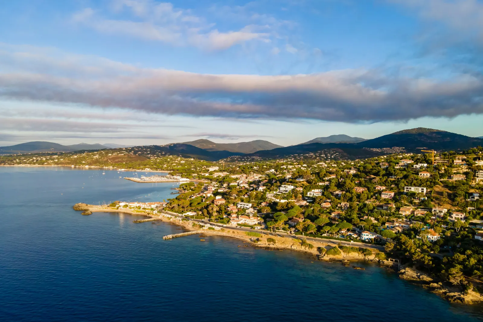 The coast of Les Issambres from the air: villas among the pines above the sea, the gulf beyond