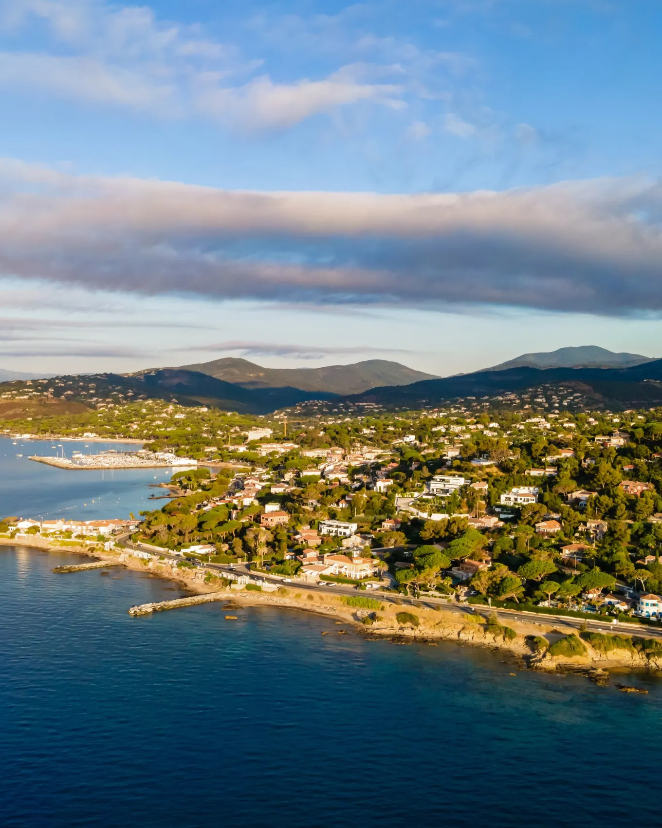 The coast of Les Issambres from the air: villas among the pines above the sea, the gulf beyond