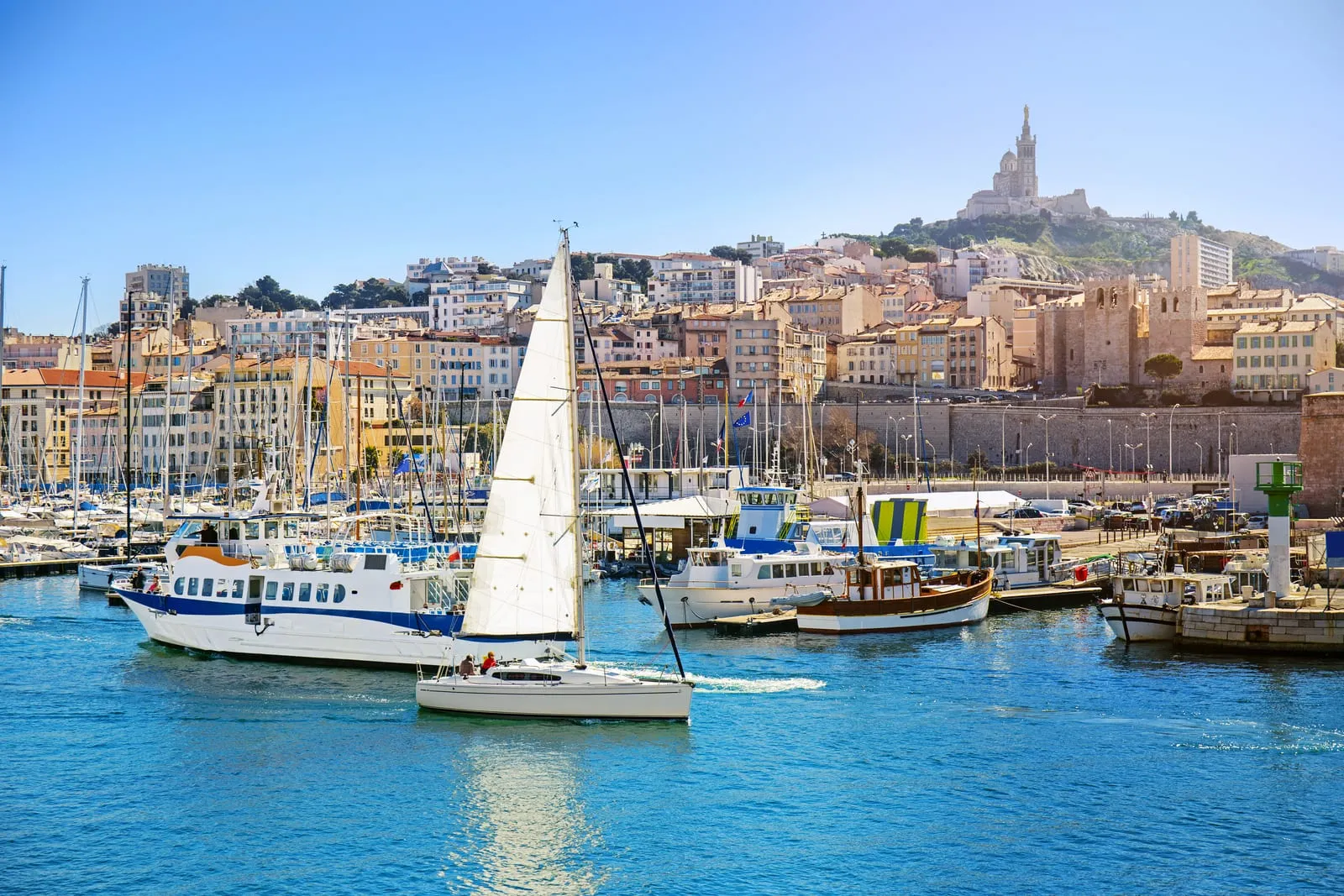 The yachts of the Vieux-Port and the Basilica of Notre-Dame de la Garde on its hill