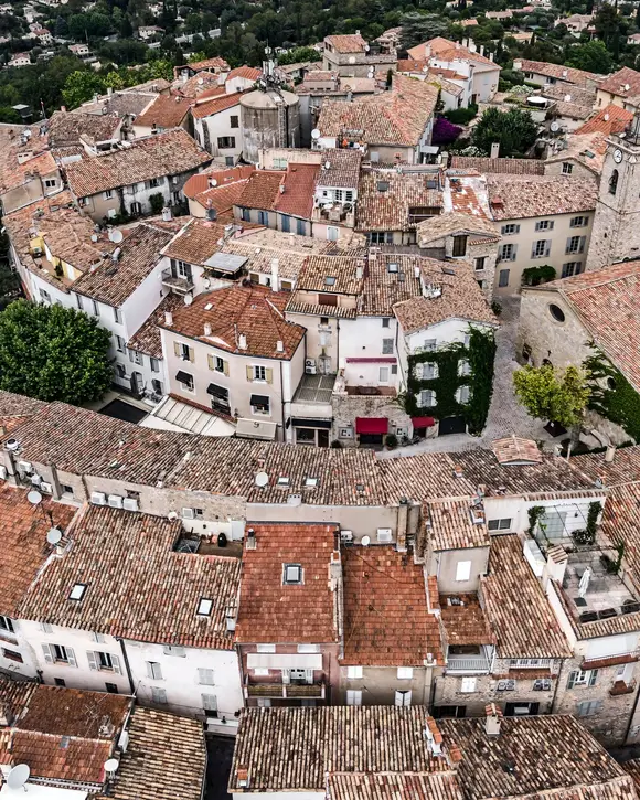 The rooftops of old Mougins from the air, its spiralling lanes and the bell tower