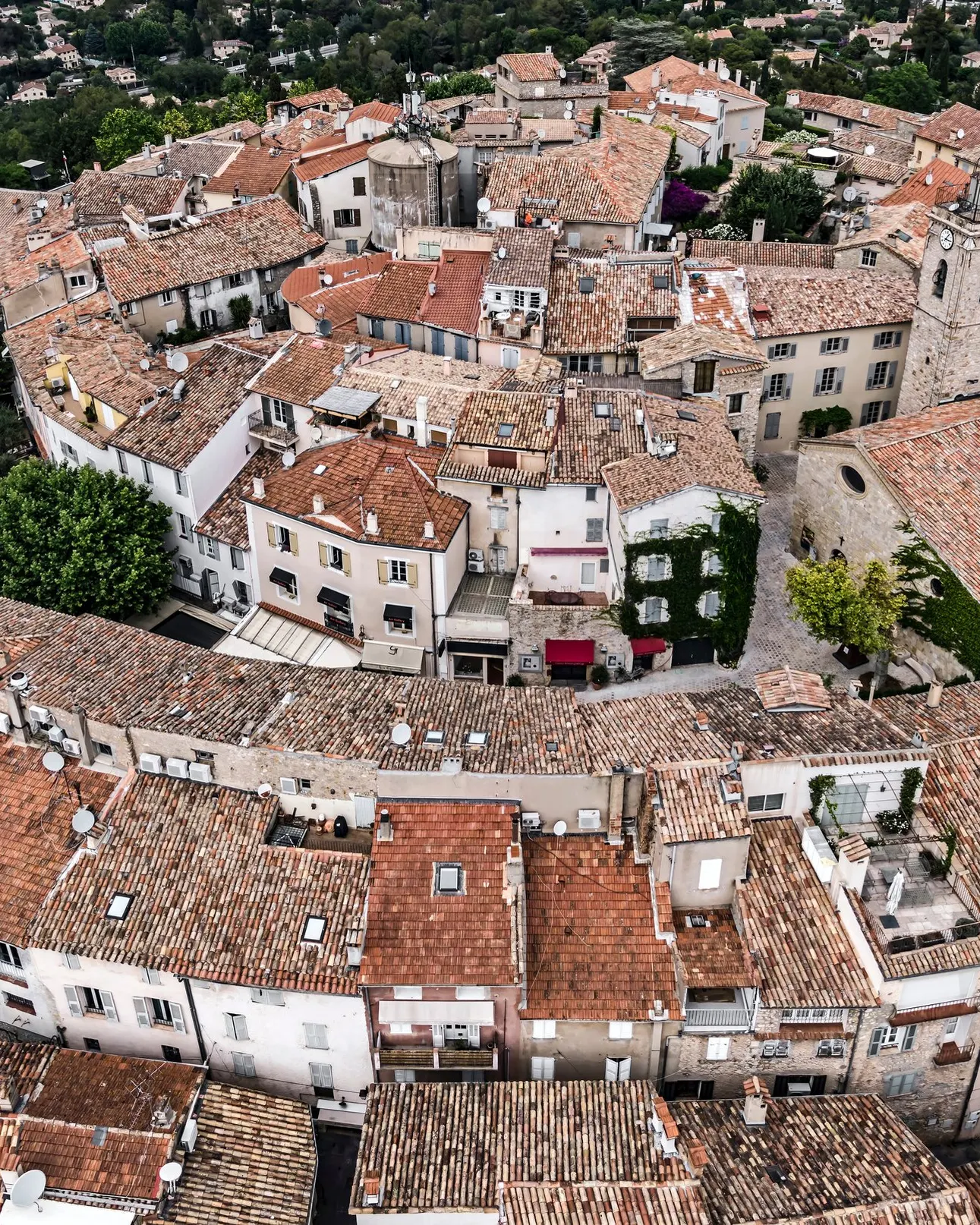 The rooftops of old Mougins from the air, its spiralling lanes and the bell tower