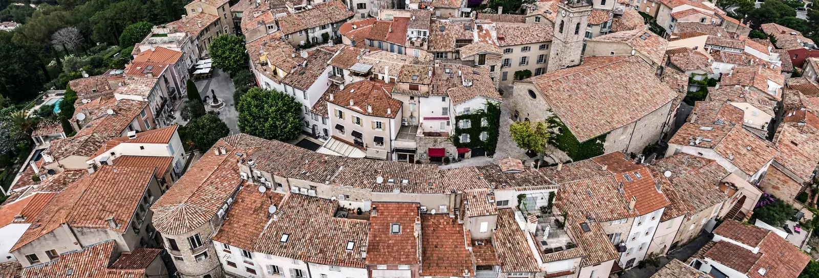 The rooftops of old Mougins from the air, its spiralling lanes and the bell tower