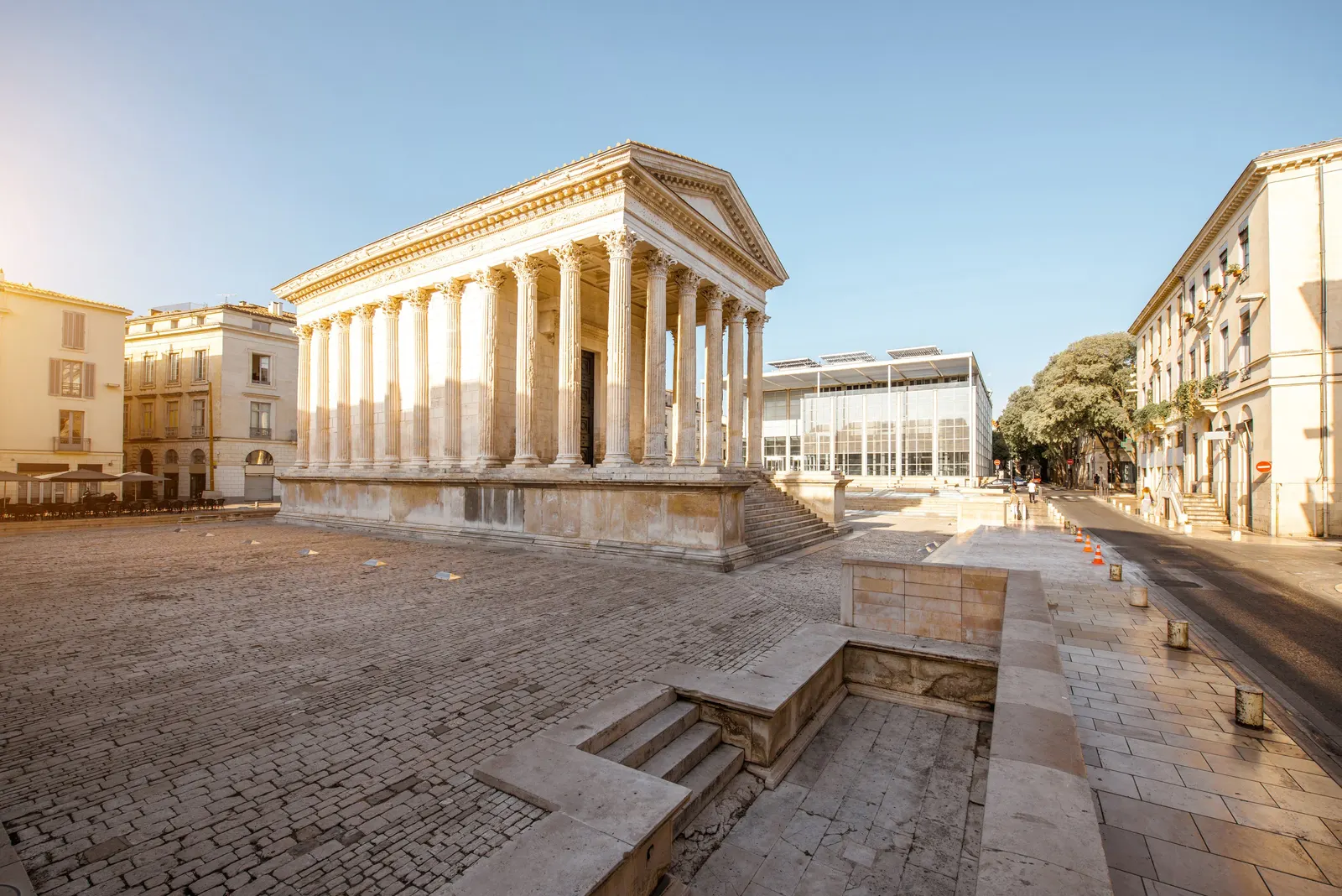 The Maison Carrée in Nîmes, a 1st-century Roman temple, in the morning sun on its paved square