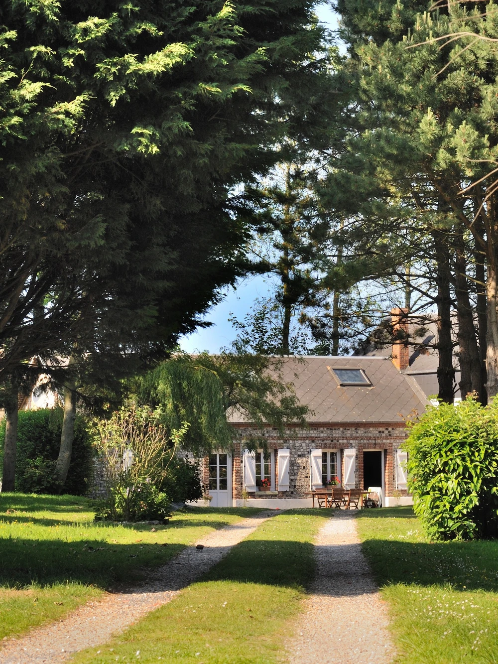 Stone country house at the end of its gravel drive, in Normandy