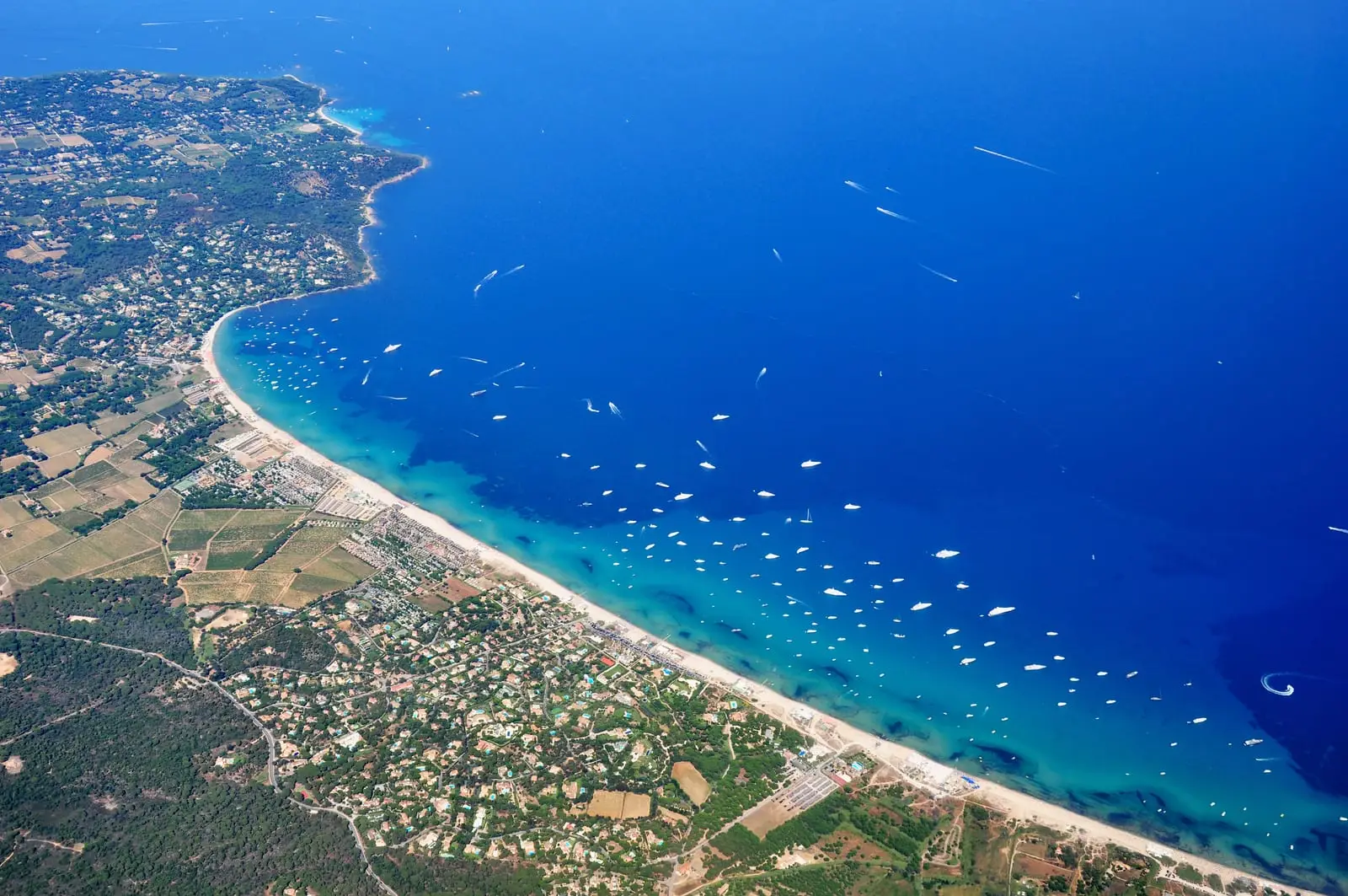 The bay of Pampelonne from the air, its beach, vineyards and villas among the pines