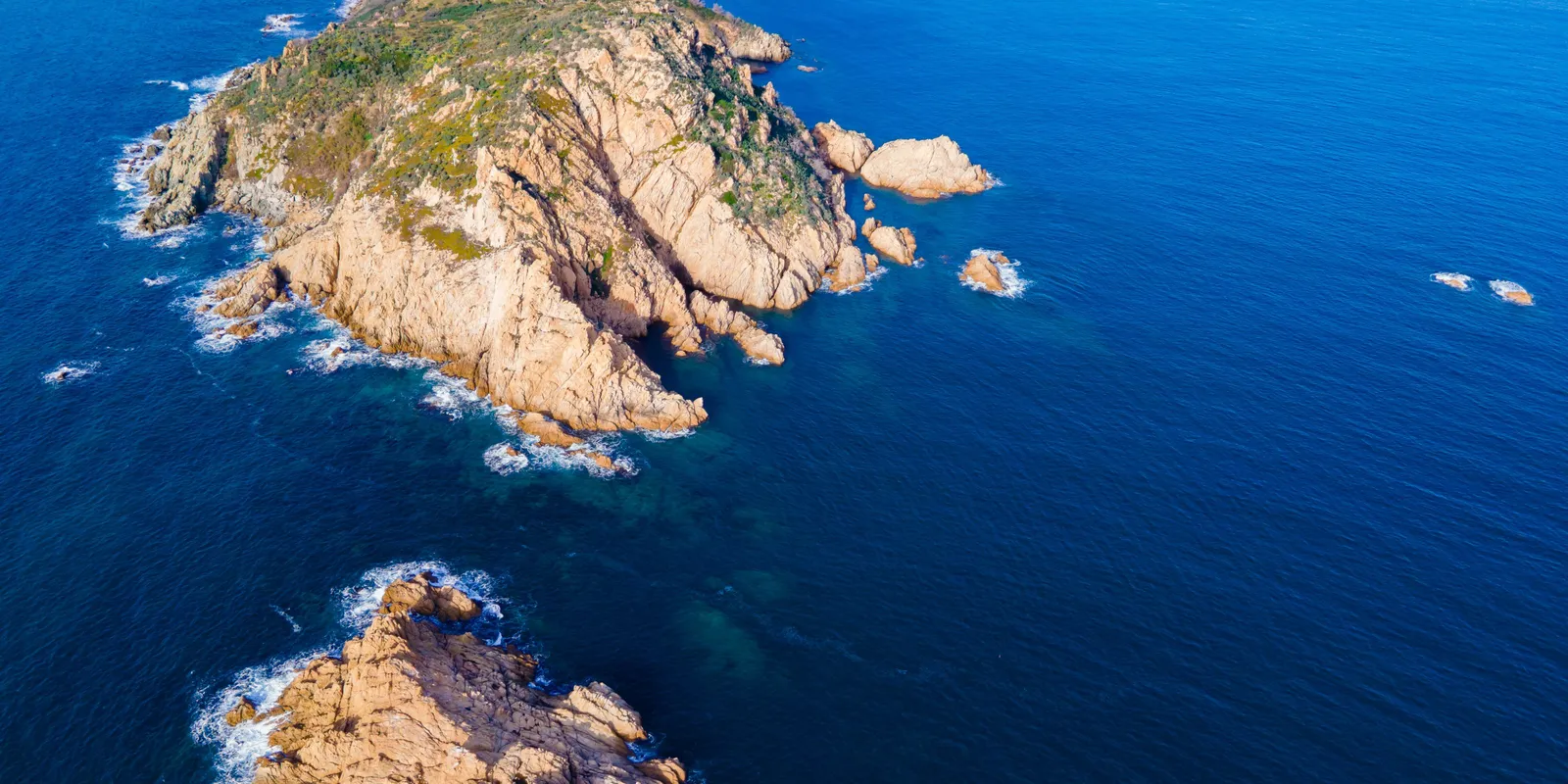 Cap Taillat from the air, its golden rocks and sandy isthmus