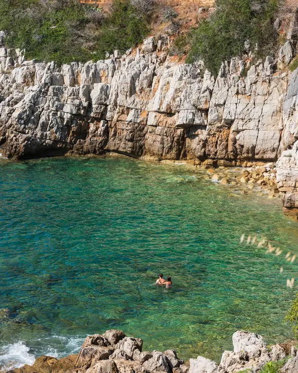 A cove with turquoise waters below the white cliffs of Saint-Jean-Cap-Ferrat