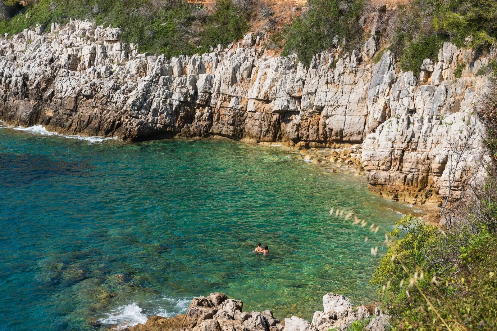 A cove with turquoise waters below the white cliffs of Saint-Jean-Cap-Ferrat