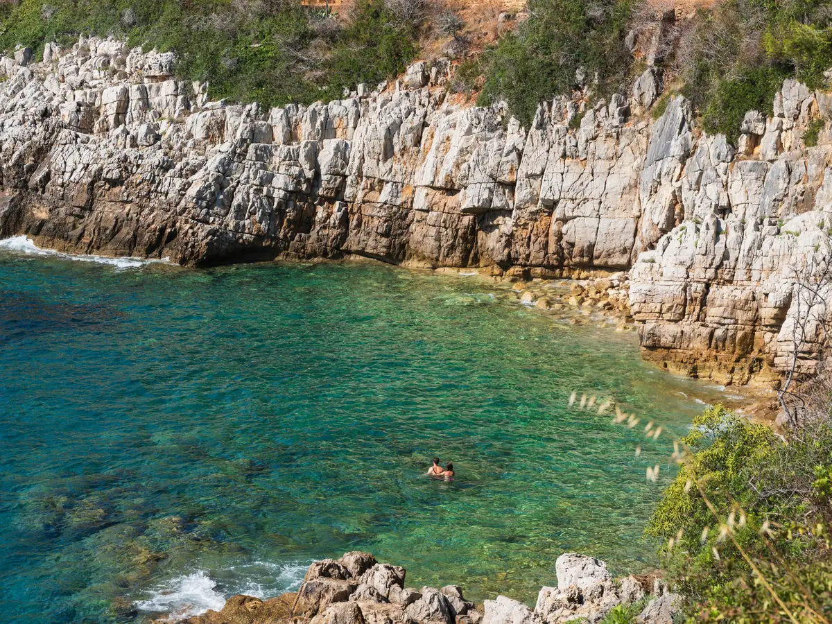 A cove with turquoise waters below the white cliffs of Saint-Jean-Cap-Ferrat