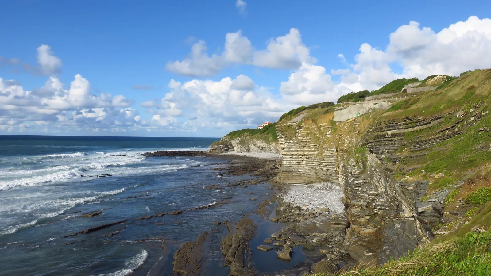 The flysch cliffs of the Basque coast at Saint-Jean-de-Luz, their tilted layers above the wave-battered rock shelf