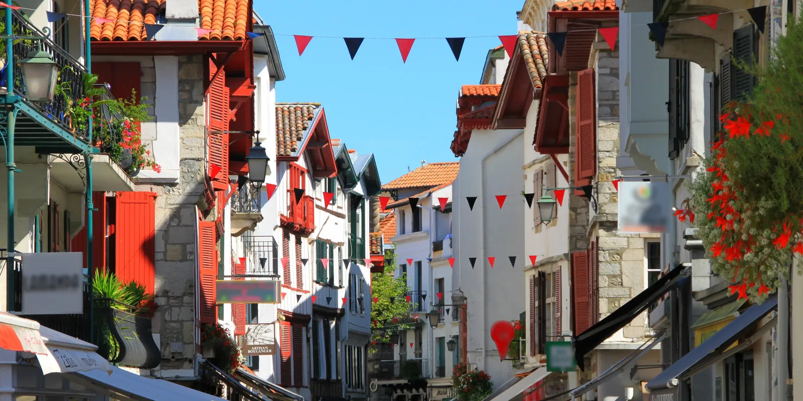 A street decked with flags and lined with Basque façades, in Saint-Jean-de-Luz