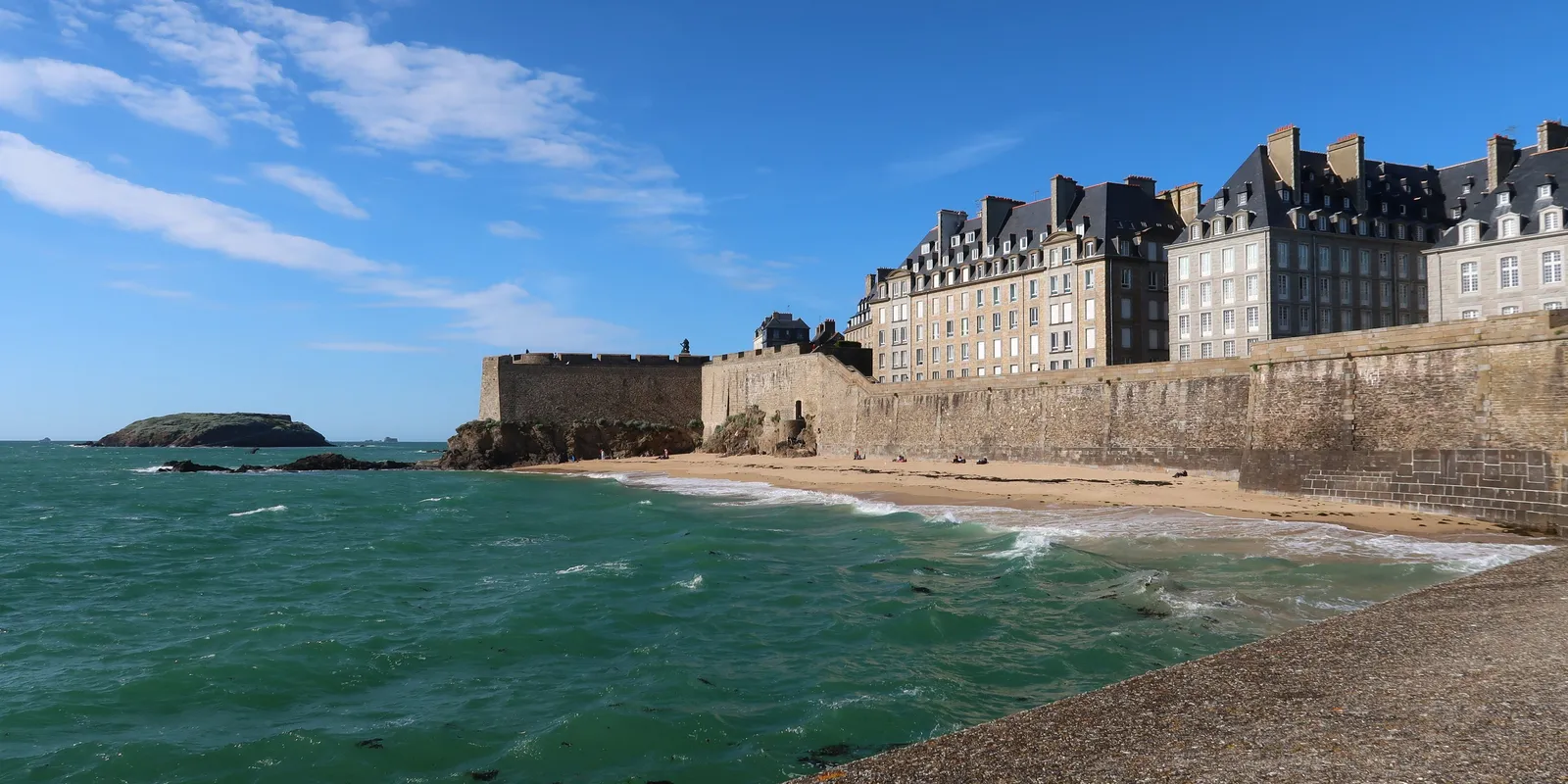 The ramparts of Saint-Malo and the Môle beach on a rising tide, the tall granite houses above