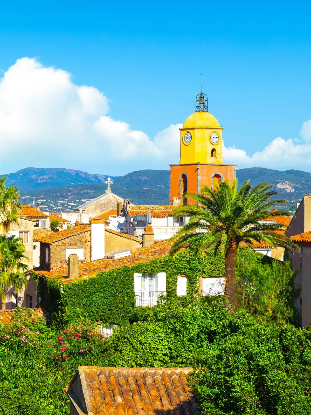The church’s yellow and ochre bell tower above the rooftops
